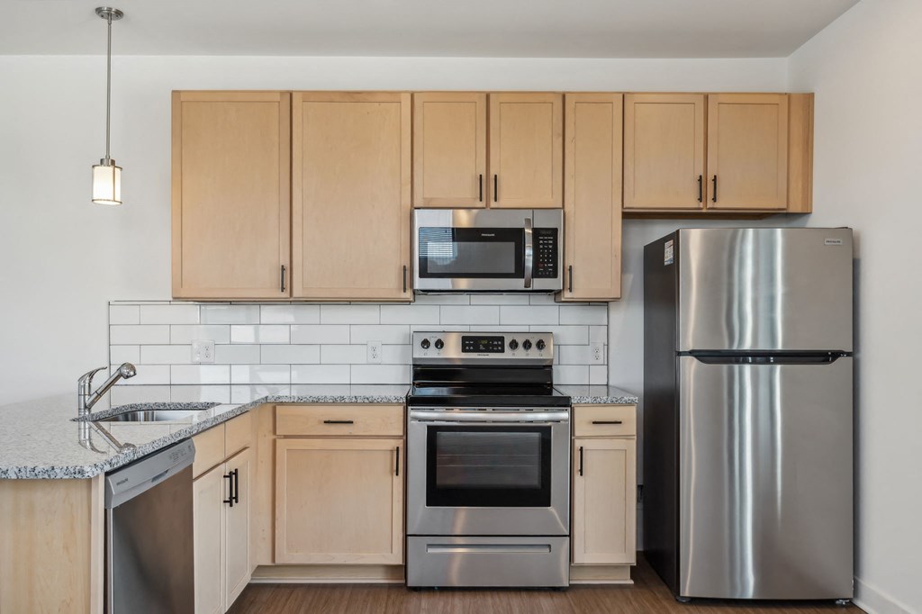a kitchen with stainless steel appliances and wooden cabinets
