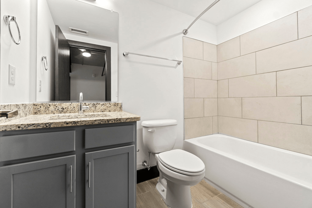 a bathroom with a sink toilet and a bath tub