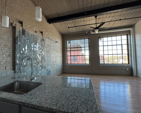A kitchen with a sink and a window.