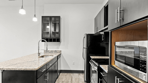 a kitchen with black appliances and granite counter tops
