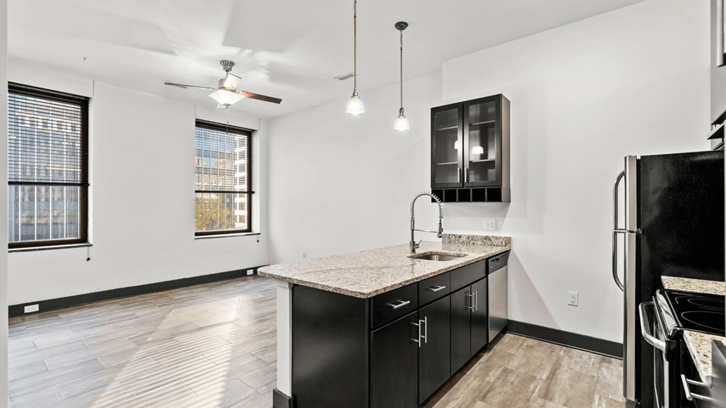a kitchen with black appliances and a counter top