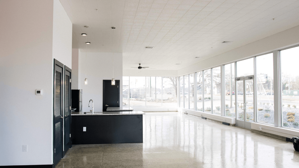 a large room with large windows and a counter in the middle of it