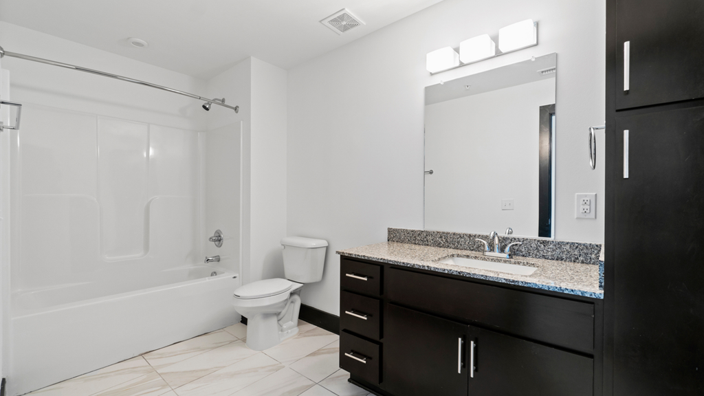 a bathroom with a sink and a toilet and a shower