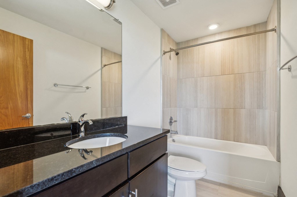a bathroom with a sink and a toilet and a shower