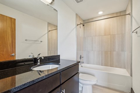 a bathroom with a sink and a toilet and a shower
