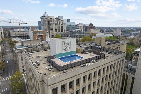 A large building with a swimming pool on the roof.