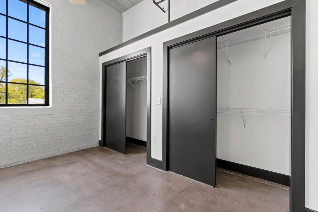 the interior of an empty room with three elevator doors