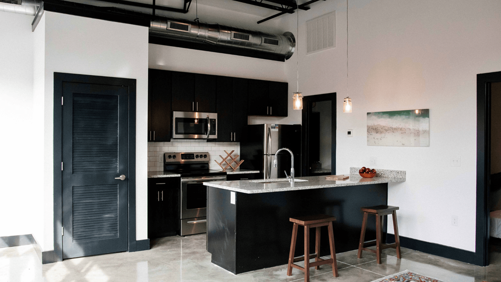 a view of a kitchen with black cabinets and a counter top