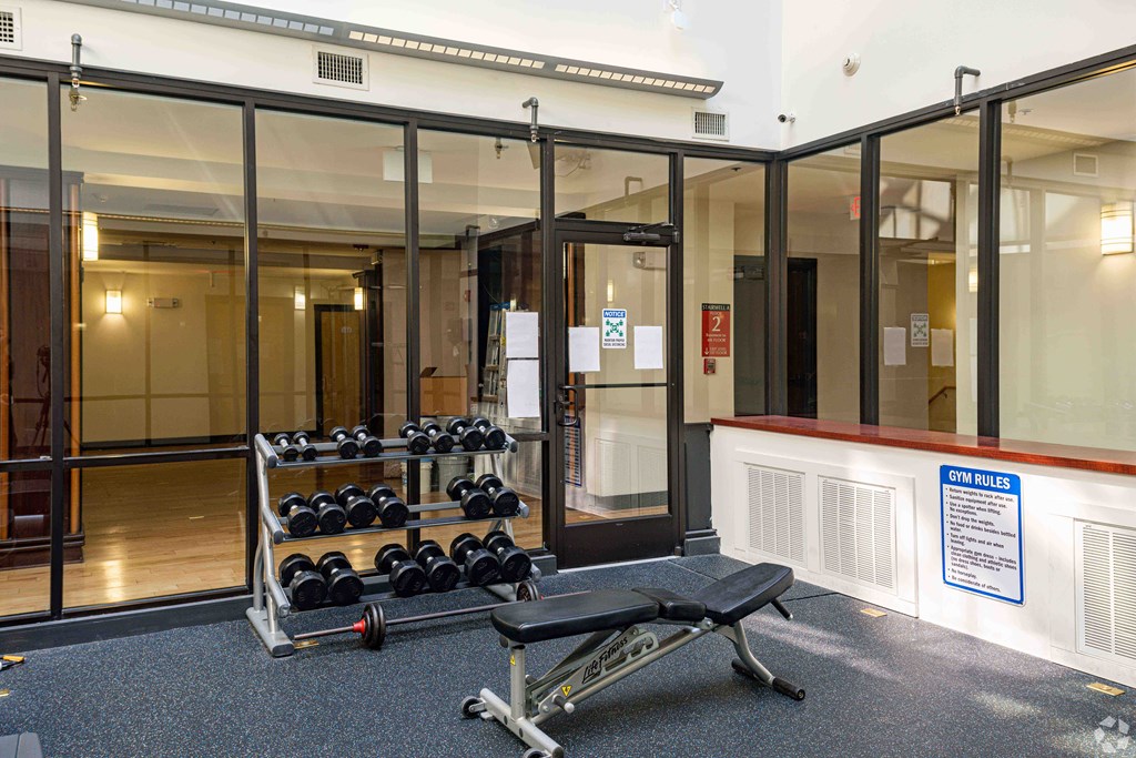 Exchange Place Apartments Fitness center, weight bench and weight rack