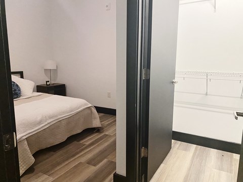 a bedroom with a bed and a sliding glass door