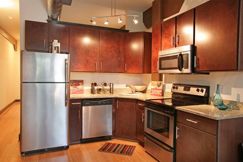 a kitchen with stainless steel appliances and wooden cabinets