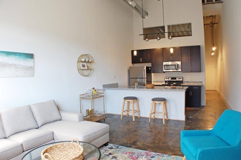 A kitchen area with a bar stool and a countertop.