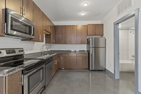A kitchen with brown cabinets and stainless steel appliances.