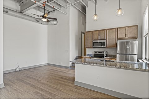 A kitchen with wooden cabinets and a granite countertop.