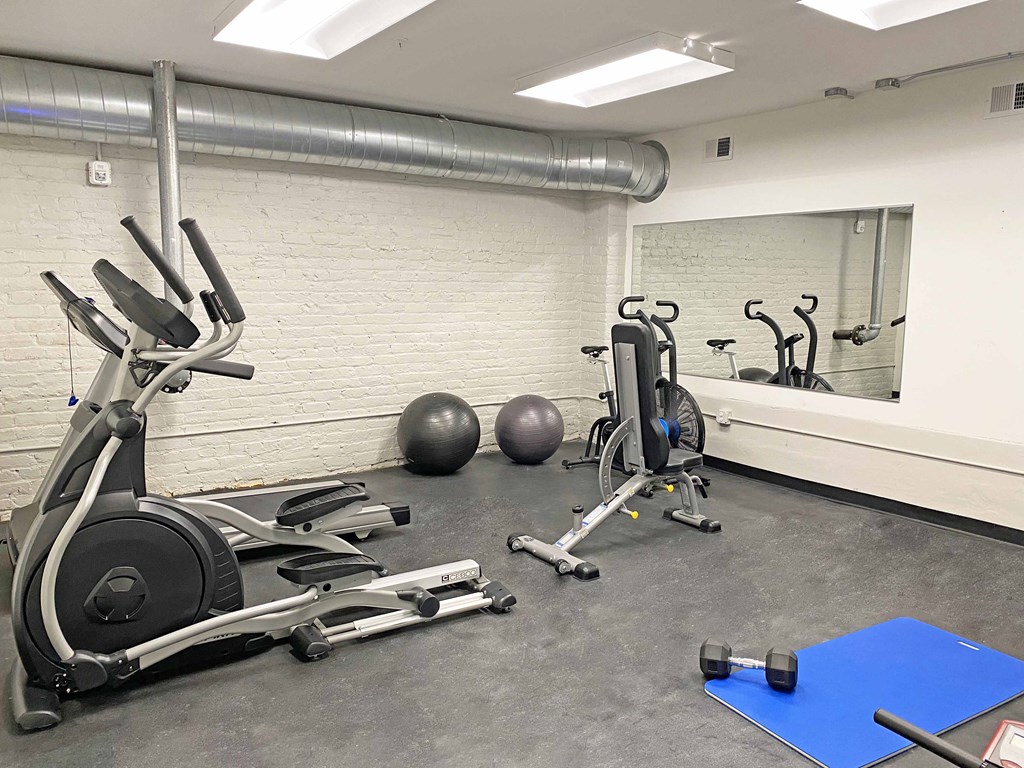 a gym with weights and other exercise equipment in a room
