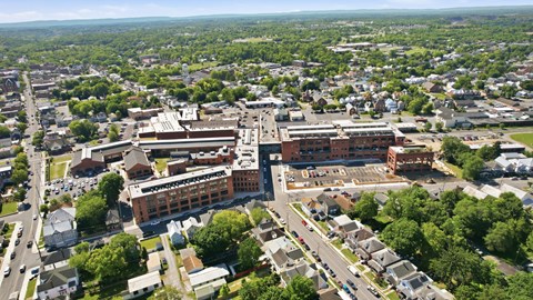 An aerial view of a town with a large building in the center.