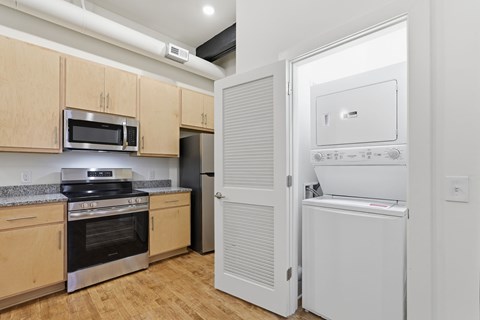 A kitchen with wooden cabinets and a white fridge.