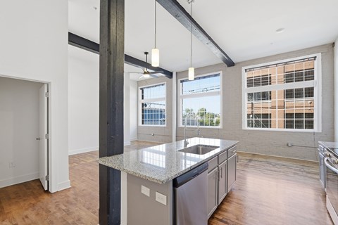 A kitchen with a large island and a view of the city.