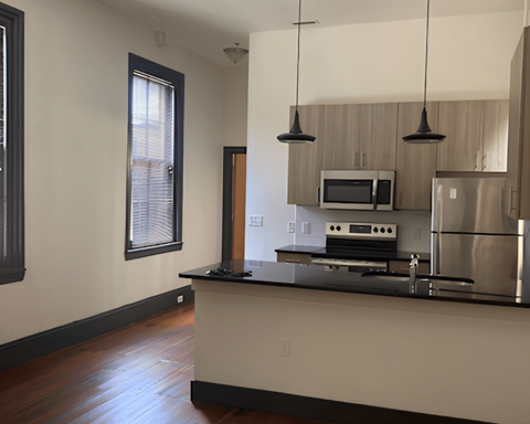 A kitchen with a stove top oven and a microwave.