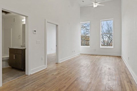 a living room with white walls and wood floors