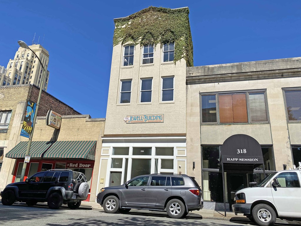 an old building on the corner of a city street