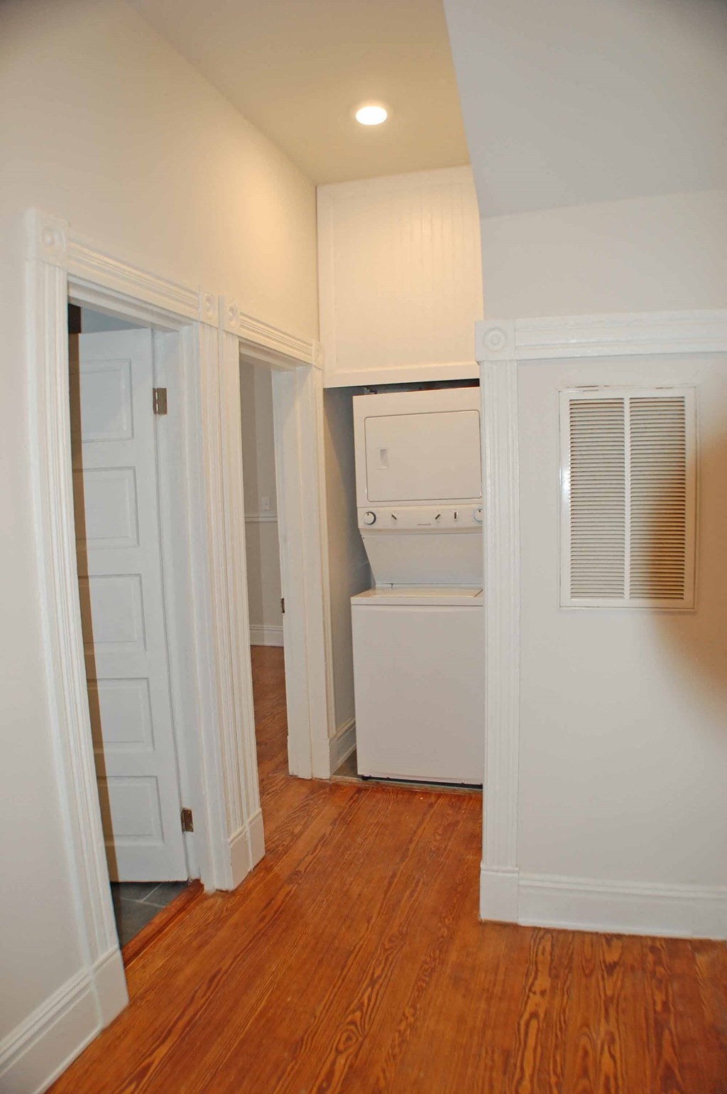 A white oven in a kitchen with wooden floors.