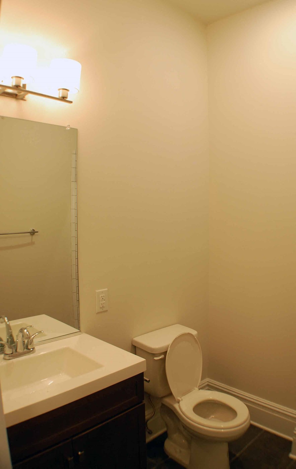 A white toilet sits next to a sink in a bathroom.