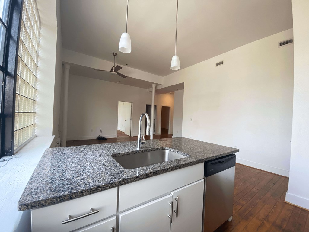 A kitchen with granite countertops and stainless steel appliances.