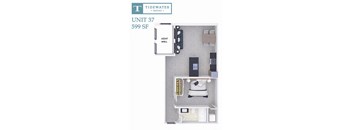A diagram of a small apartment layout with a bed, desk, and cupboard.