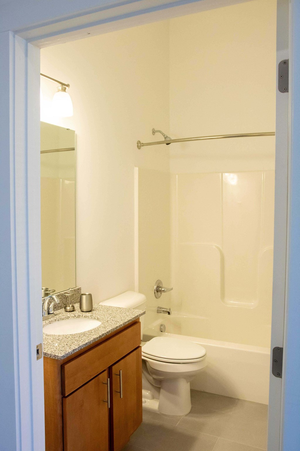 A white toilet sits next to a sink in a bathroom.