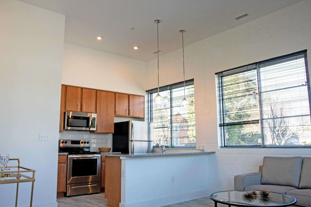 A modern kitchen with wooden cabinets and stainless steel appliances.