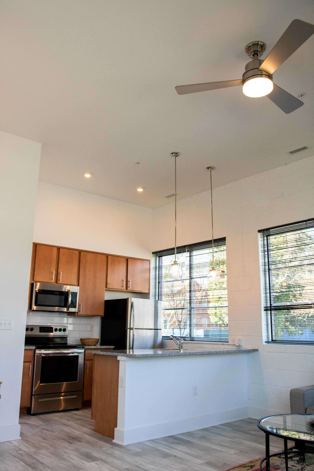 A modern kitchen with wooden cabinets and stainless steel appliances.