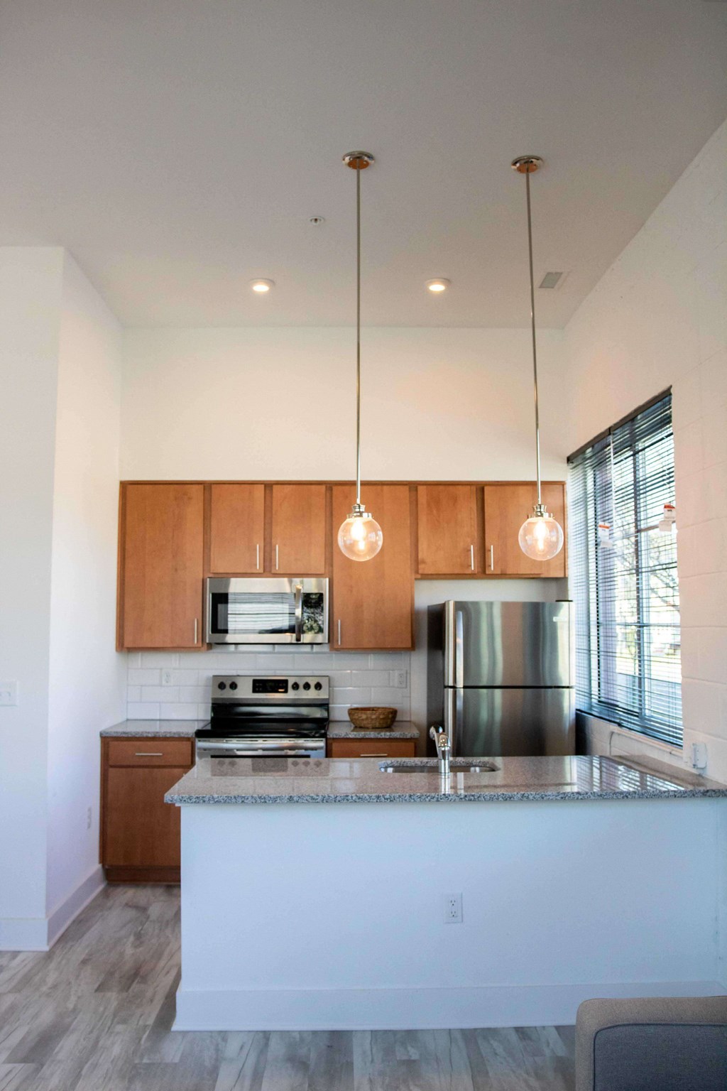 A modern kitchen with wooden cabinets and stainless steel appliances.