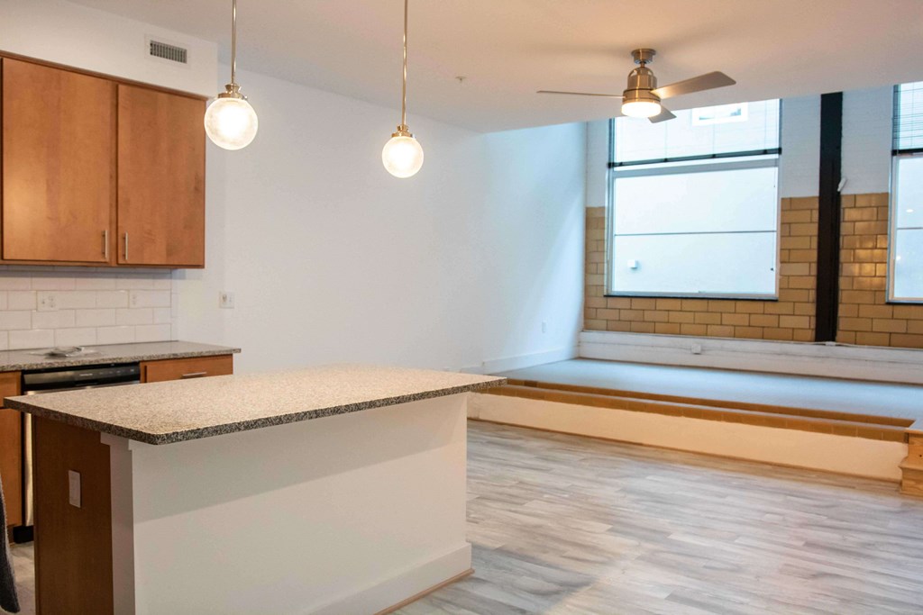 A kitchen with a countertop and wooden cabinets.