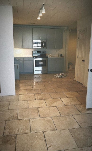 A kitchen with tile flooring and a white door.