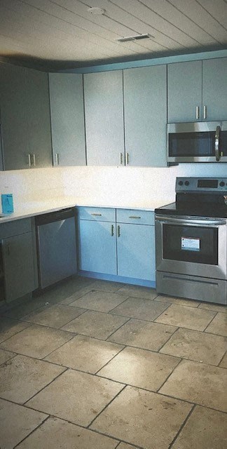 A kitchen with a stove top oven and microwave.