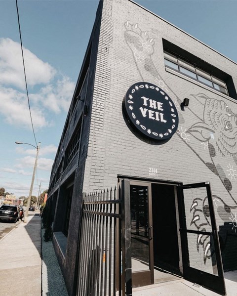 A black and white building with a sign that says "The Veil".