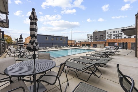 A poolside area with a table and chairs.
