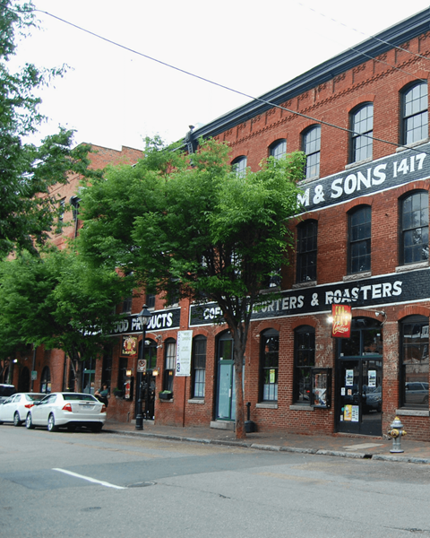 A street view of a building with the sign "M&Sons 1417" on it.