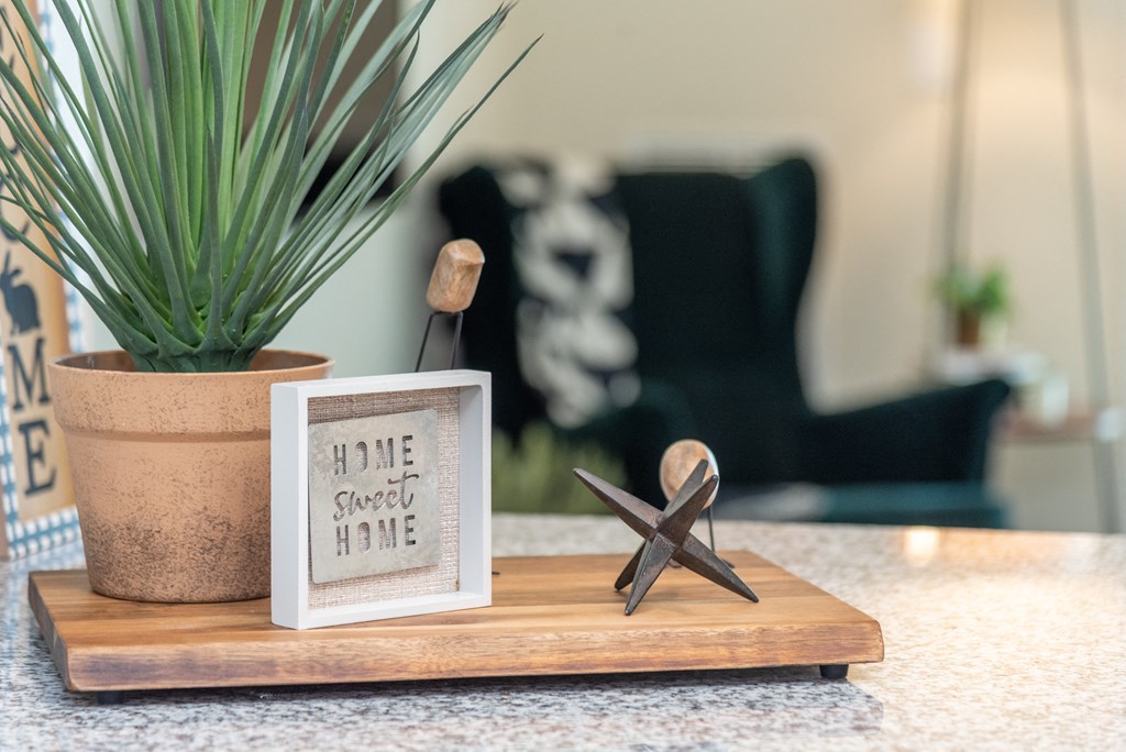 a wooden tray with a starfish and a picture on it on a counter next to a