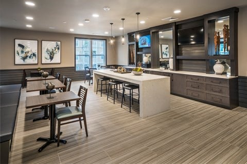 A modern kitchen with a dining table and chairs.