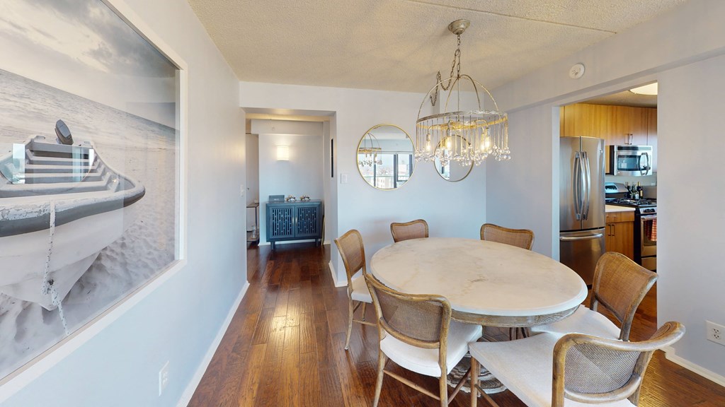 A dining room with a white table and chairs at 10 West Apartments, New York
