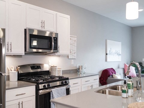 a kitchen with stainless steel appliances and white cabinets