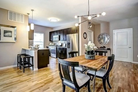 a kitchen and dining room with a table and chairs