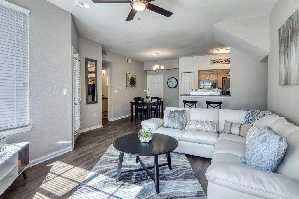 A living room with a white couch and a black coffee table at Rivertree Apartments, Riverview, FL, 33578