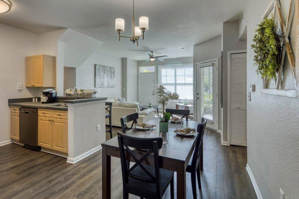 a kitchen and dining room with a table and chairs