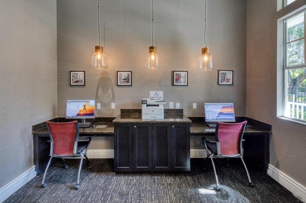 an office with two desks and two computer monitors
