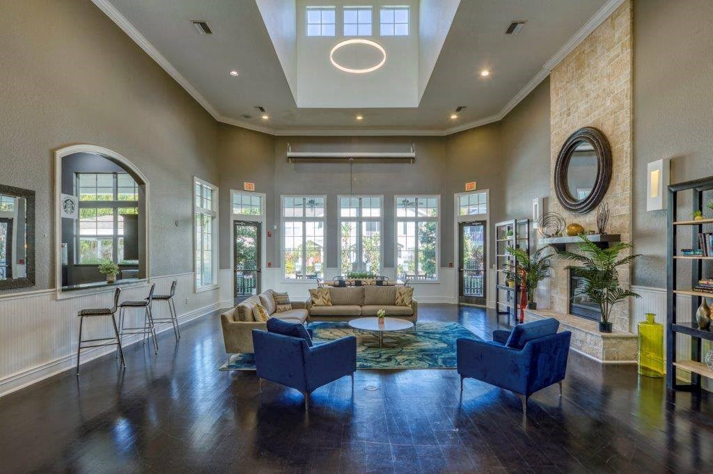 a living room with couches and chairs and a large window