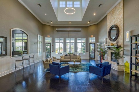 a living room with couches and chairs and a large window