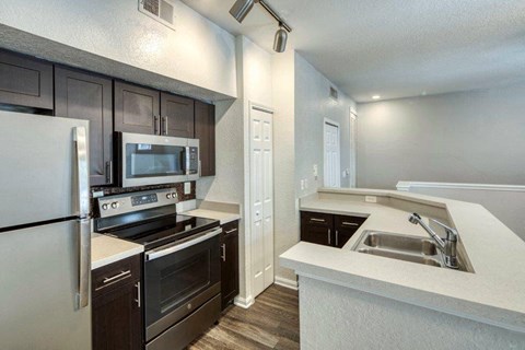 a kitchen with stainless steel appliances and a sink